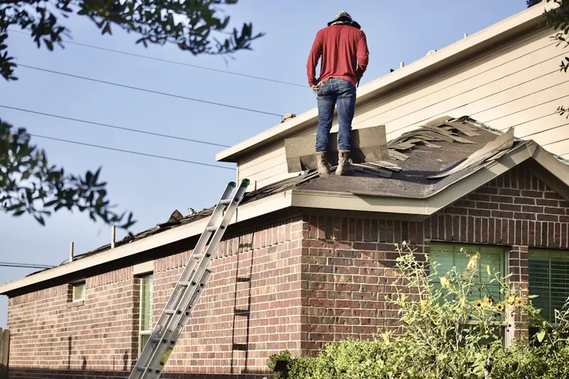 Professional roofer working on a residential roof in Milo-Grogan